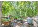 Back deck with a grill, dining set, and potted plants, perfect for outdoor cooking and entertaining at 686 Hillwood Ct, Dacula, GA 30019