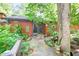 Charming backyard with garden, stone pathway, mature plantings and access to home at 686 Hillwood Ct, Dacula, GA 30019