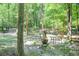 Patio area with outdoor furniture surrounded by privacy fence and trees at 686 Hillwood Ct, Dacula, GA 30019