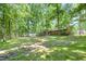 Expansive backyard with mature trees creates a peaceful retreat; featuring greenhouse and deck at 686 Hillwood Ct, Dacula, GA 30019