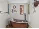 Bathroom with copper soaking tub, vintage decor, and unique fixtures at 686 Hillwood Ct, Dacula, GA 30019