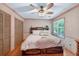 Bright bedroom featuring natural light, ceiling fan, and hardwood floors at 686 Hillwood Ct, Dacula, GA 30019