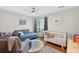 Well-lit bedroom features hardwood floors, comfortable seating, and a cozy atmosphere at 686 Hillwood Ct, Dacula, GA 30019