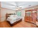 Bedroom features hardwood floors, a comfortable bed, and ample storage, creating a peaceful retreat at 686 Hillwood Ct, Dacula, GA 30019