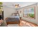 Bright bedroom with hardwood floors, a comfortable bed, and ample natural light, ideal for relaxation at 686 Hillwood Ct, Dacula, GA 30019