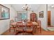 Cozy dining room with hardwood floors and a classic china cabinet adjacent to a window at 686 Hillwood Ct, Dacula, GA 30019