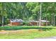 Home exterior with mature trees and landscaping at 686 Hillwood Ct, Dacula, GA 30019