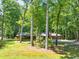 Home exterior with driveway and surrounding trees at 686 Hillwood Ct, Dacula, GA 30019