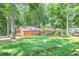 Exterior view of a home with mature trees and grass at 686 Hillwood Ct, Dacula, GA 30019