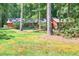 Exterior view of a home with mature trees and grass at 686 Hillwood Ct, Dacula, GA 30019