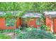 Home exterior featuring a decorative front door surrounded by lush landscaping at 686 Hillwood Ct, Dacula, GA 30019