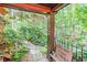 Inviting front porch with welcome sign and lush garden view, creating a warm and welcoming entrance at 686 Hillwood Ct, Dacula, GA 30019