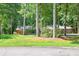 Single-story home with lush, mature trees and green lawn at 686 Hillwood Ct, Dacula, GA 30019