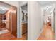 Hallway view showcasing hardwood floors and access to bathroom and other rooms, creating seamless flow at 686 Hillwood Ct, Dacula, GA 30019