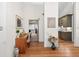 Inviting hallway with hardwood floors, artful decor, and seamless transitions to the living spaces and the kitchen at 686 Hillwood Ct, Dacula, GA 30019