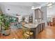 Bright and airy living room featuring an open concept kitchen and views of lush outdoor greenery at 686 Hillwood Ct, Dacula, GA 30019