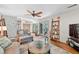 Spacious living room with comfortable seating, stylish decor, and seamless connection to the lush outdoors at 686 Hillwood Ct, Dacula, GA 30019