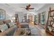 Well-decorated living room featuring an open layout, a large sofa, and views of the outdoor scenery at 686 Hillwood Ct, Dacula, GA 30019