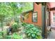 Charming side yard with lush greenery, mature plants, and quaint stone pathway, enhancing the home's appeal at 686 Hillwood Ct, Dacula, GA 30019