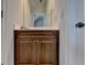 Bathroom featuring a mirror, a countertop, and dark wooden cabinets at 1668 Legrand Cir, Lawrenceville, GA 30043