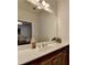 Bathroom featuring a mirror, a countertop, and dark wooden cabinets at 1668 Legrand Cir, Lawrenceville, GA 30043
