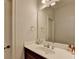 Bathroom featuring a mirror, a countertop, and dark wooden cabinets at 1668 Legrand Cir, Lawrenceville, GA 30043