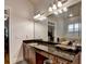 Bathroom vanity with granite countertops, mirror, and sink at 1668 Legrand Cir, Lawrenceville, GA 30043