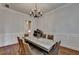 The dining room features wainscoting, a modern light fixture and hardwood flooring at 1668 Legrand Cir, Lawrenceville, GA 30043