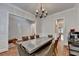 This dining room includes a view of a living area and hardwood flooring at 1668 Legrand Cir, Lawrenceville, GA 30043