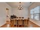 Elegant dining room features an exquisite chandelier and natural light through the window at 1668 Legrand Cir, Lawrenceville, GA 30043