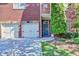 Close up on a brick house exterior with a blue door and two-car garage, showcasing its charming facade at 1668 Legrand Cir, Lawrenceville, GA 30043