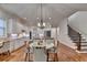 Open kitchen featuring an island, white cabinets, and a view of the staircase and dining area, ideal for entertaining at 1668 Legrand Cir, Lawrenceville, GA 30043