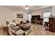 Cozy living room with a ceiling fan, comfortable seating, and a leafy patterned rug at 1668 Legrand Cir, Lawrenceville, GA 30043