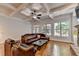 Open living room boasts coffered ceilings, hardwood floors, and ample natural light at 1668 Legrand Cir, Lawrenceville, GA 30043