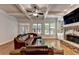 Open living room boasts coffered ceilings, stone fireplace, and hardwood floors at 1668 Legrand Cir, Lawrenceville, GA 30043