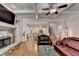 Open living room boasts coffered ceilings, stone fireplace, and easy access to kitchen at 1668 Legrand Cir, Lawrenceville, GA 30043