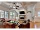 Cozy living room with coffered ceiling, stone fireplace, and an abundance of natural light at 1668 Legrand Cir, Lawrenceville, GA 30043