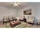 Sitting area with four chairs, a leafy patterned rug, and a ceiling fan at 1668 Legrand Cir, Lawrenceville, GA 30043