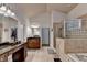 Well-lit main bathroom boasts tile floors, dual vanities, and walk-in shower at 1668 Legrand Cir, Lawrenceville, GA 30043