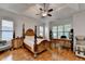 Spacious main bedroom features hardwood floors, tray ceiling, and ceiling fan at 1668 Legrand Cir, Lawrenceville, GA 30043