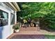 Brick patio with potted plants, ironwork details and lush greenery at 1668 Legrand Cir, Lawrenceville, GA 30043