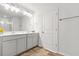 Bright bathroom with double sink vanity, ample lighting and wood-look flooring at 3641 Princeton Ave, Atlanta, GA 30337