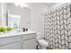Bright bathroom with modern fixtures, geometric shower curtain, and gray vanity at 3641 Princeton Ave, Atlanta, GA 30337