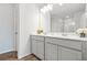 Bathroom featuring double vanity, framed mirror, ample lighting and wood-look flooring at 3641 Princeton Ave, Atlanta, GA 30337