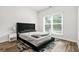 Comfortable bedroom with a large window, wood floors, and neutral decor at 3641 Princeton Ave, Atlanta, GA 30337