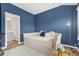 This bedroom features blue walls, a daybed, a fluffy rug and an attached bathroom at 3641 Princeton Ave, Atlanta, GA 30337
