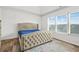 Bedroom featuring a large window and comfortable bed with a tufted headboard at 3641 Princeton Ave, Atlanta, GA 30337