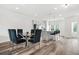 Bright dining area with seating for six, an island with bar stools, and modern lighting at 3641 Princeton Ave, Atlanta, GA 30337