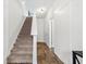 Bright hallway with hardwood floors, leading to a carpeted staircase and other rooms at 3641 Princeton Ave, Atlanta, GA 30337