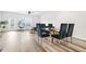 Open living area with a dining table, egg chair, wood-look floors, and lots of natural light at 3641 Princeton Ave, Atlanta, GA 30337